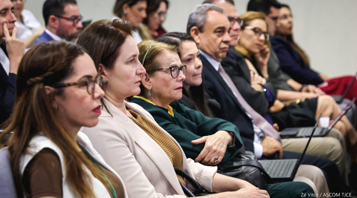 Foto com várias pessoas sentadas na plateia atentas ao conteúdo ministrado pelo palestrante Foto com várias pessoas sentadas na plateia atentas ao conteúdo ministrado pelo palestrante